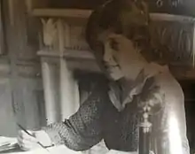 Ka writing at her desk, undated