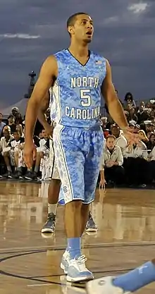 A basketball player wearing a jersey that reads "North Carolina".