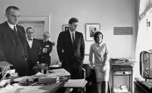 President Kennedy watching the flight on TV together with the First Lady, Vice President Johnson and others