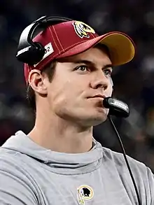 Kevin O'Connell wearing a cap and headset