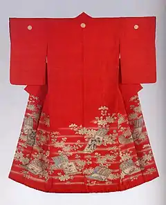 A scarlet red kimono with short sleeves viewed from the back. The kimono is lined in a different, warmer shade of red, and has a padded hem. The kimono has three crests along the shoulders, and is decorated with a design of hazy mist and hanging scroll motifs along the hem, reaching higher towards the front of each side.