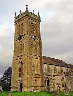 Yellow stone building with square tower.