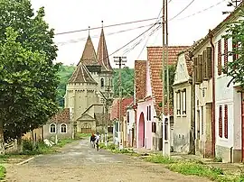 Street in Șeica Mică with view of the Saxon fortified church.