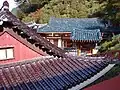 Guinsa Hall with Maroon and Blue-Green Glazed Roof Tiles.