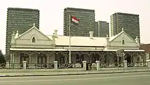 A Dutch colonial-style house with the flag of the South African Republic flying outside.