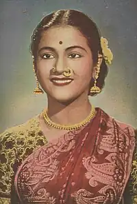 Young smiling Indian woman wearing a sari.