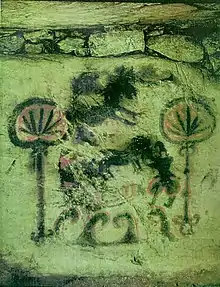 A cave drawing with two figures resembling cannabis leaves