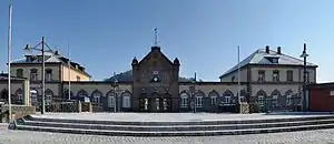 Wide building with wings and two-story towers