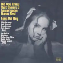 A black-and-white photo of the artist with hers and the album's names along the left in yellow and more credits below in white.