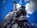 One of the Landseer Lions with the column behind, June 2021