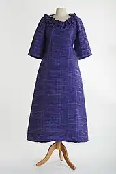 Lavender evening gown in pleated linen with 3/4 length sleeves and a frilled neckline by Sybil Connolly