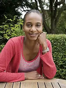 Smiling woman wearing a red cardigan