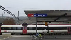 White train at canopy-covered platform