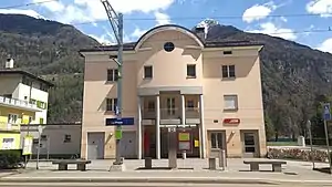 Three-story stone building with hip roof