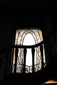 Stained glass window in stairway by Jacques Gruber