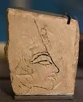 Limestone trial piece showing head of Nefertiti. Mainly in ink, but the lips were cut out. Reign of Akhenaten, Amarna. Petrie Museum