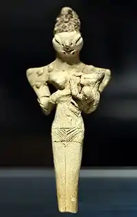 Lizard-headed nude woman nursing a child, Ur, Ubaid 4 period, 4500-4000 BCE, Iraq Museum. "The elongated head, similar to the figures found at Eridu, could represent an elaborate headdress or possibly cranial binding".