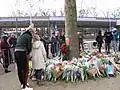 Local residents bring flowers to commemorate the victims of the tram attack