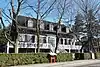 Louis Bertrand House surrounded by trees