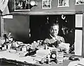 Louis Armstrong in his dressing room, a bottle of Pluto Water at left, 1946