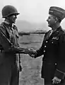 Lieutenant Ernest Childers, a Muscogee, being congratulated by General Jacob L. Devers shortly after receiving the Medal of Honor in 1944.