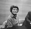 Black-and-white photograph of Lys Assia in 1964 seated behind a table.