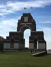 War memorial with French and United Kingdom flags on top.