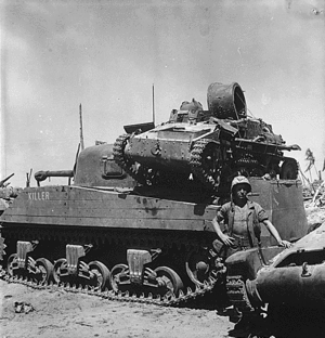 A captured Type 94 tankette with a damaged turret, on the engine deck of a USMC M4 Sherman tank at Kwajalein