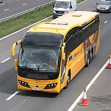 Photograph of the South West Falcon coach on the M5 motorway sporting new yellow livery