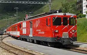 Deh 4/4II 93 with a train in Sedrun