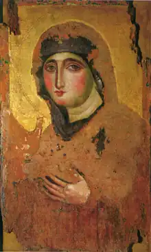 Slightly faded painting of a woman wearing a black veil, staring out of the portrait.  Her hands are raised.  The image is on a gold background.