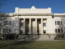 A granite building with a pillared facade.