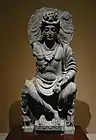 Maitreya, with Kushan devotee couple. 2nd century Gandhara.