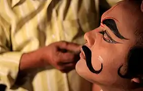 Artist applying makeup for Bhaona