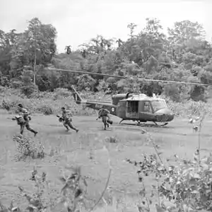 Sarawak Rangers (present-day part of the Malaysian Rangers) consisting of Ibans leap from a Royal Australian Air Force Bell UH-1 Iroquois helicopter to guard the Malay–Thai border from potential Communist attacks in 1965, two years before the war starting in 1968.