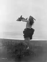 Mandan hunter with buffalo skull, c. 1909