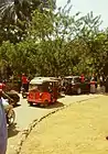 Tuk-Tuk surrounded by demonstrators