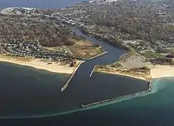 Mouth of the Manistee River at Lake Michigan. Downtown Manistee and Manistee Lake are in the background.