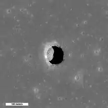 High Sun view of the Mare Tranquillitatis pit crater revealing boulders on an otherwise smooth floor. Image is 400 meters wide, north is up, NAC M126710873R.