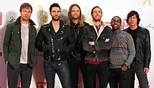 Maroon 5 are looking gently towards the camera.