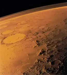 The southern rim of Argyre basin, formed by the Charitum Montes. Adjacent are sinuous ridges, theorized to be glacial eskers. The crater Galle is seen in the background.