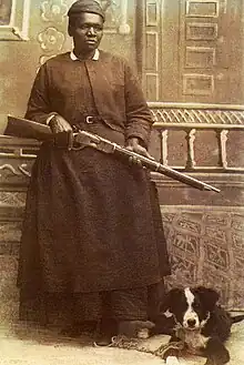 Sepia-tone photograph of Mary Fields, holding a rifle