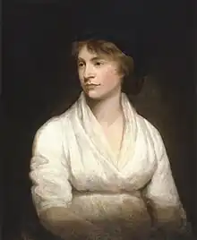 Left-looking portrait of a slightly pregnant woman in a white dress