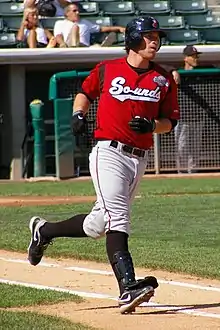 A baseball player in red and gray