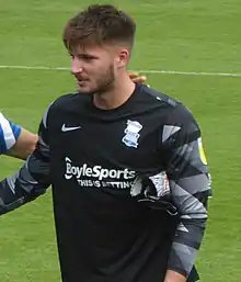 Head and upper torso of a white man wearing goalkeeping kit.