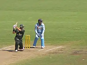 Matthew Hayden smashing Irfan Pathan for another boundary as Dhoni looks on