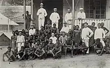 Employees of the Hamburg trading company Hernsheim & Co. on Matupi, New Britain, c 1890. Managing director Max Thiel stands on the veranda holding his hat in one hand.