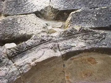 Color photograph of an engraved stone arch.