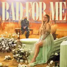 A man in a jacket and trousers and a blond woman in a pastel-colored gown surrounded by flowers and broken pillars. The yellow text "Bad for Me Meghan Trainor Teddy Swims" stands above them.