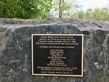 The text reads, "Samuel 'Mingo Jack' Johnson lynched without a fair trial at the former site of the Eatontown Lockup, midnight, March 5, 1886. New Jersey's only documented 19th century lynching.  The Mango Jack Remembrance Committee: Inice Hennessy, Rodney Jackson, Alden Small Sr., James Stone, Carolyn Storey-Hodge, Rose Terry, Sonny Thornton, Sondra Thompson, The Paranormal Rangers. Honorary Members: Congregation Shaare Tefilah Bene Moshe, Councilman Meir Araman.